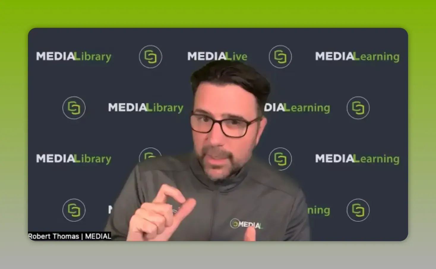 Rob Thomas speaking on MEDIAL’s webinar background while discussing AI enhancements for video learning.