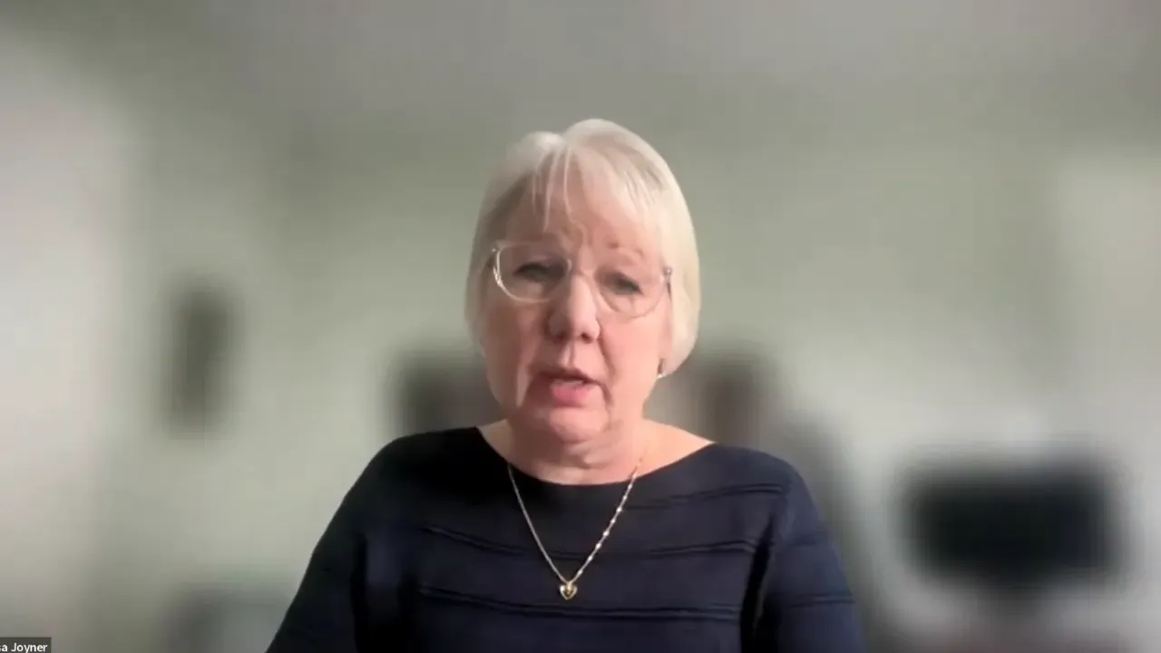 Clear head-and-shoulders view of an instructor speaking on a Zoom call with blurred background.